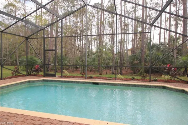 a view of a swimming pool with a yard