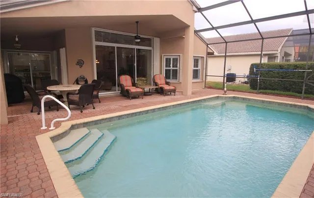 a view of a swimming pool with sitting area