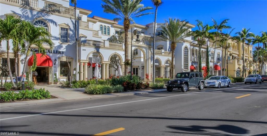 2322 Butterfly Palm Drive Naples, FL 34119 - Photo 26 of 32 a street with cars parked in front of it