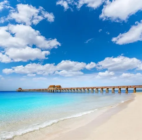 a view of a house with potted plants and large trees