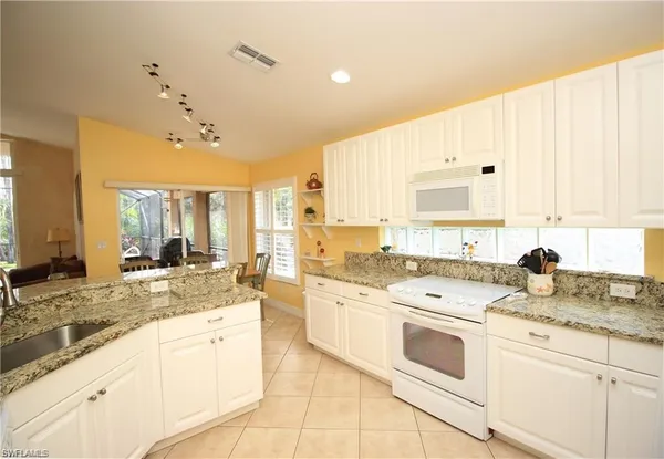 a large white kitchen with a window