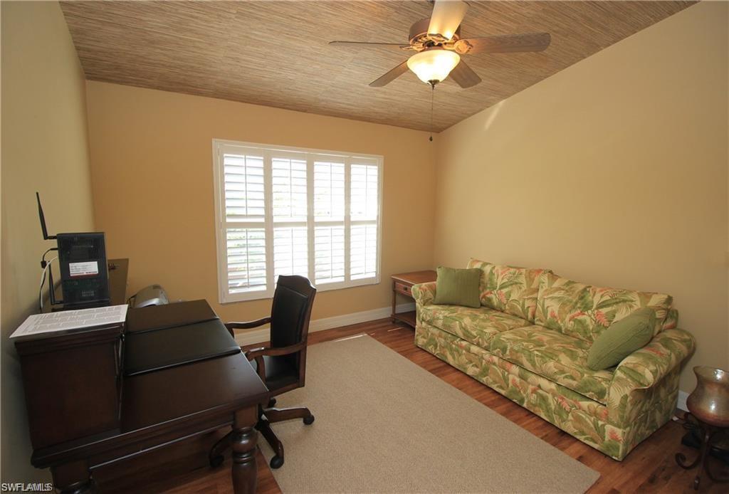 2322 Butterfly Palm Drive Naples, FL 34119 - Photo 9 of 32 a living room with furniture and a window