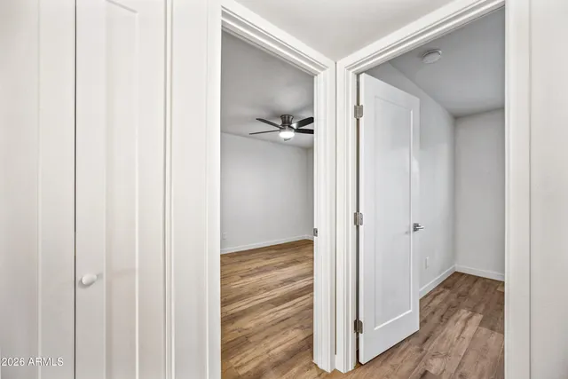 a view of a hallway with closet and wooden floor