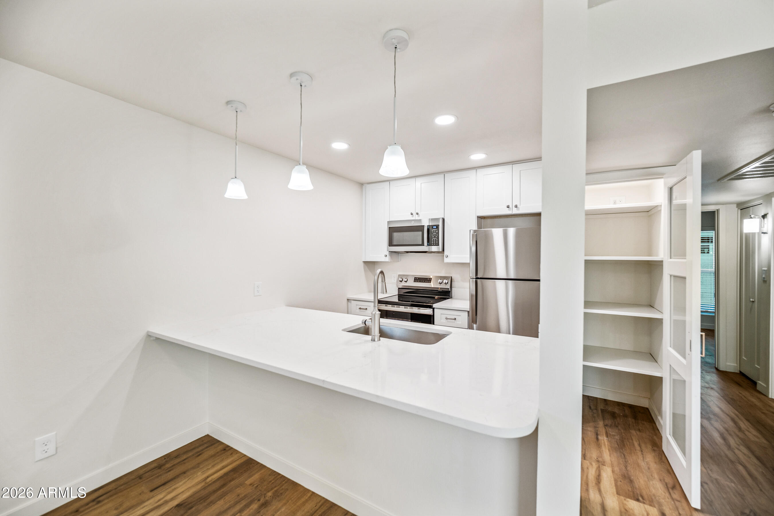 4139 North 27th Street, Unit 1 Phoenix, AZ 85016 - Photo 8 of 31 a kitchen with stainless steel appliances a refrigerator and microwave