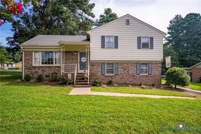 a front view of a house with yard and green space