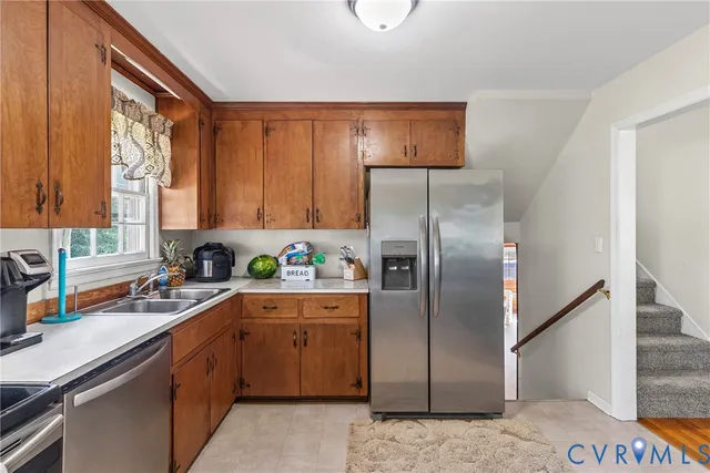 a kitchen with a refrigerator sink and cabinets