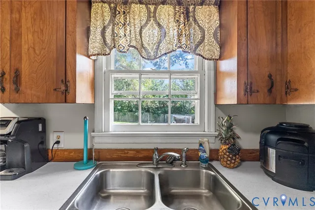 a kitchen with a sink and a stove next to a window