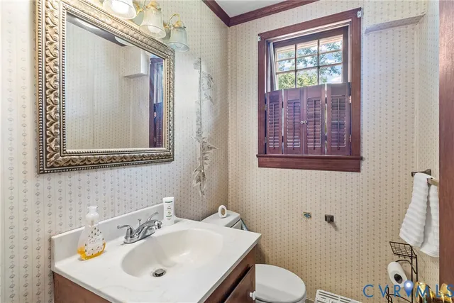 a bathroom with a toilet sink and mirror