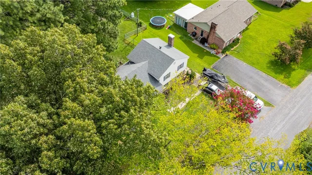 an aerial view of a house with swimming pool and garden