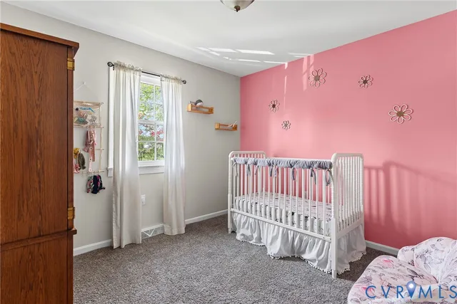 a view of a bedroom with furniture and windows