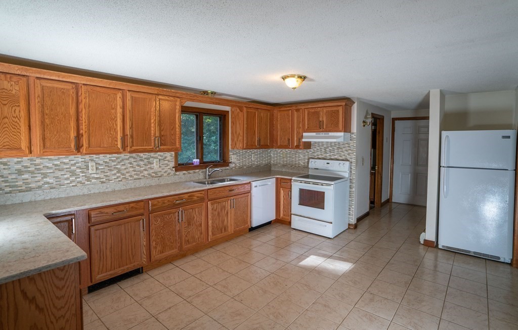 367 Bay Road Amherst, MA 01002 - Photo 3 of 27 a kitchen with a refrigerator sink and cabinets