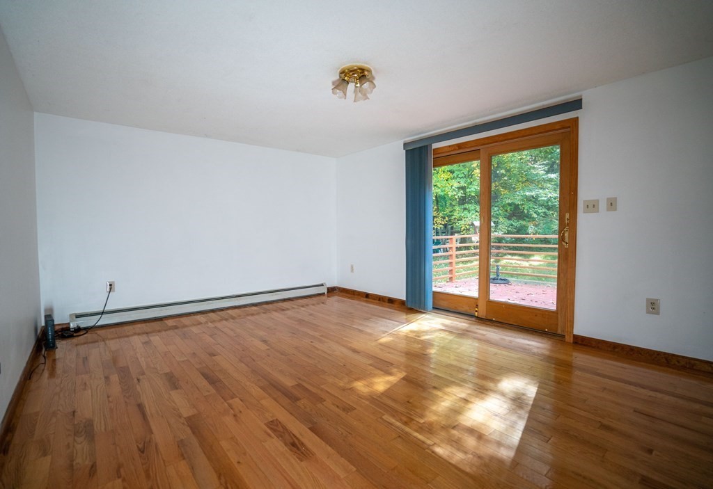 367 Bay Road Amherst, MA 01002 - Photo 6 of 27 a view of an empty room with wooden floor and a window