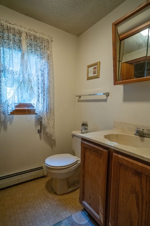367 Bay Road Amherst, MA 01002 - Photo 9 of 27 a bathroom with a granite countertop toilet sink and mirror