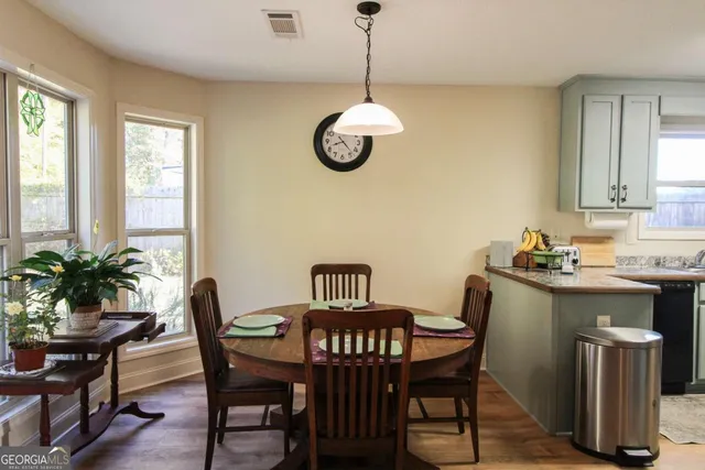 a view of a dining room with furniture window and wooden floor