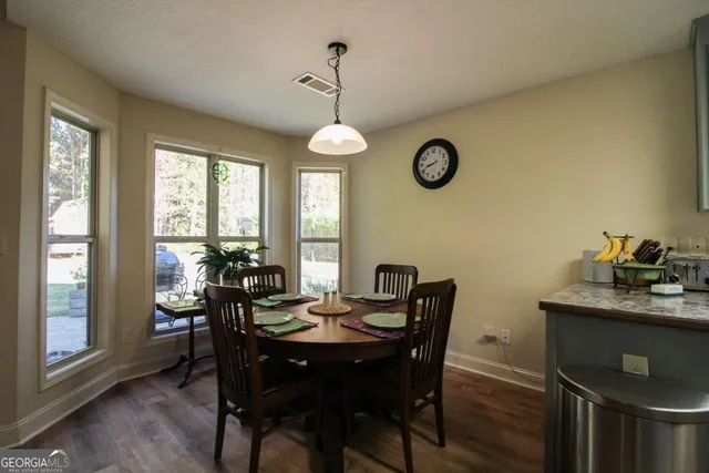 a view of a dining room and a table and chairs