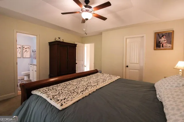 a bedroom with a bed and a dresser