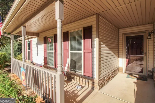 a view of a balcony with wooden floor and fence