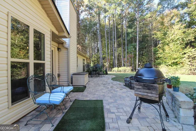 a view of a chairs and table in backyard