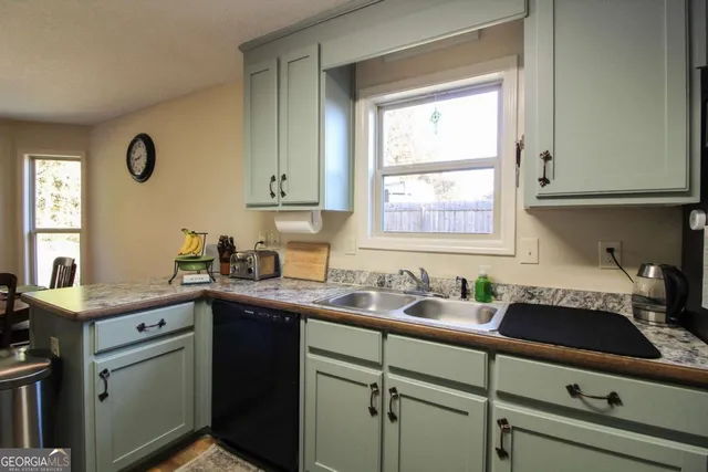 a kitchen with a sink cabinets and window
