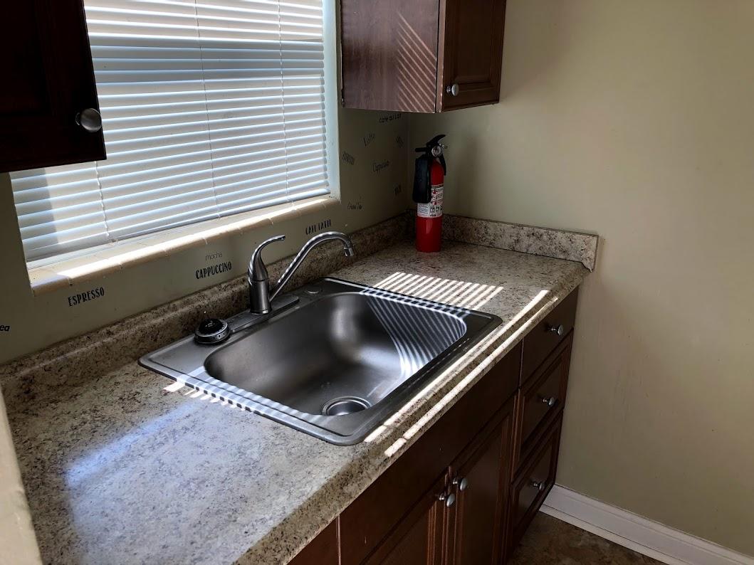 26 Wisconsin Street, Unit 2 Palm Springs, FL 33461 - Photo 2 of 6 a kitchen with a stove and a sink