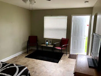a living room with furniture rug and a window