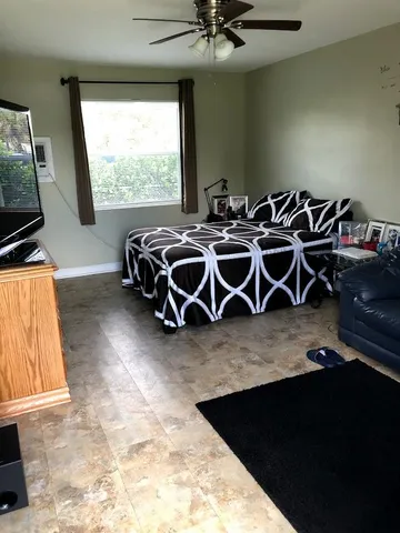 a view of a livingroom with furniture and a window