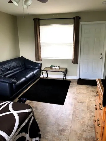 a living room with a couch and a large window