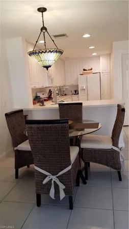 a room with a table chairs and a wooden floor