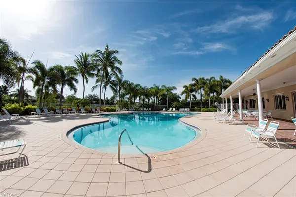 a swimming pool with outdoor seating and yard