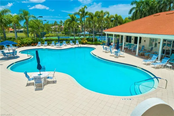 a view of a swimming pool with chairs