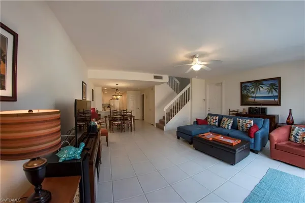 a living room with furniture and a chandelier