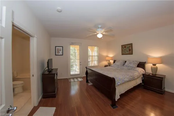 a spacious bedroom with a bed and a chandelier