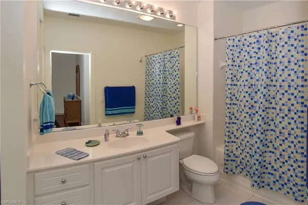 a bathroom with a sink toilet vanity and shower