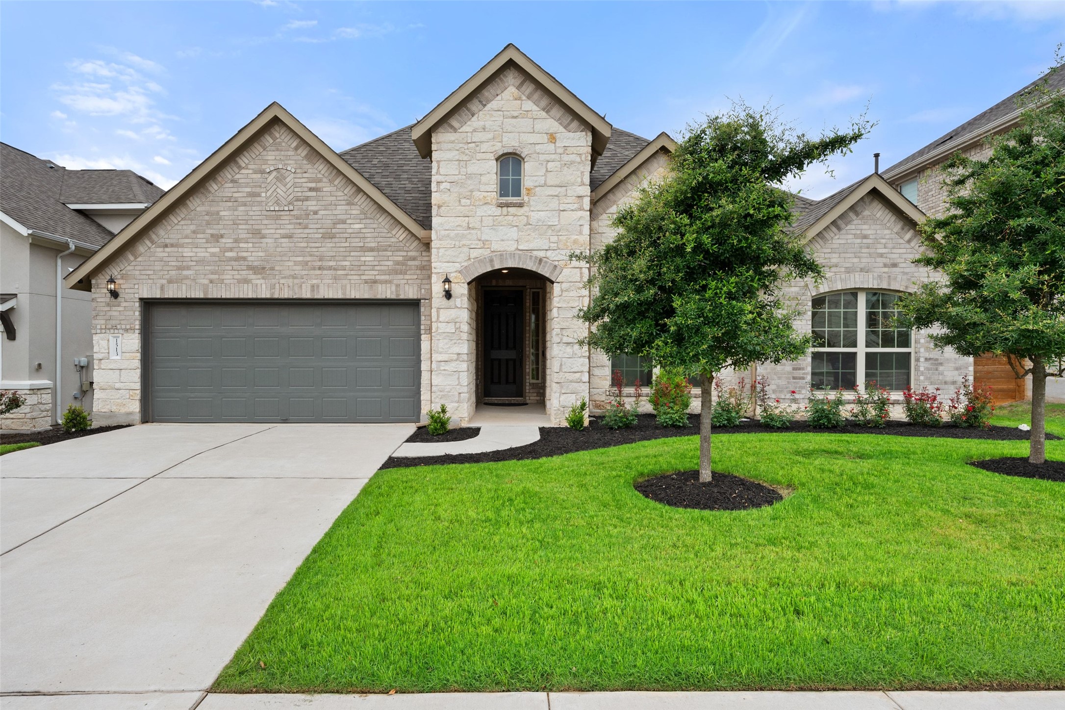 1513 Hinterwald Street Leander, TX 78641 - Photo 1 of 40 a front view of a house with a garden