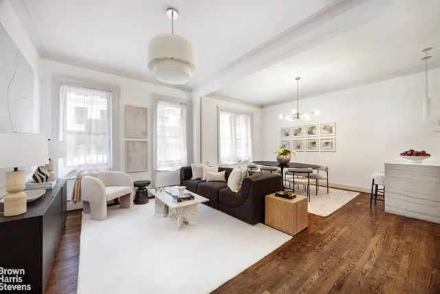 a living room with furniture or chandelier and a wooden floor