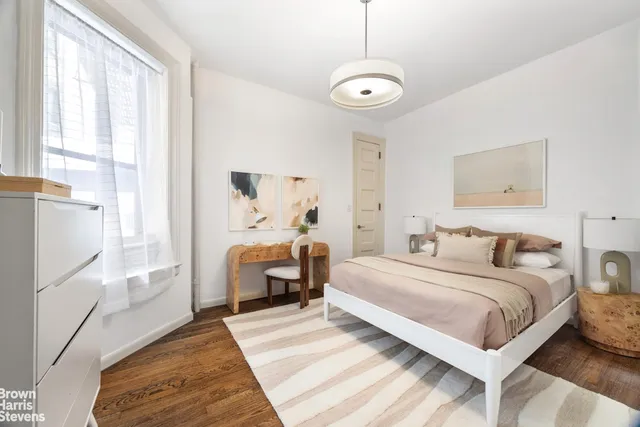 a bedroom with a large bed and a window