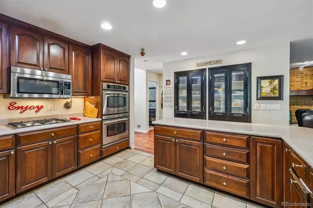 a kitchen with stainless steel appliances granite countertop a stove sink and microwave
