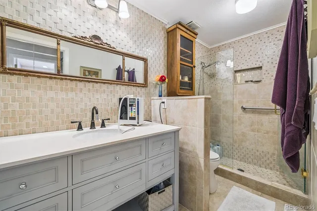 a bathroom with a shower sink and mirror