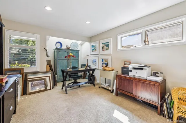 a view of a livingroom with workspace and a window