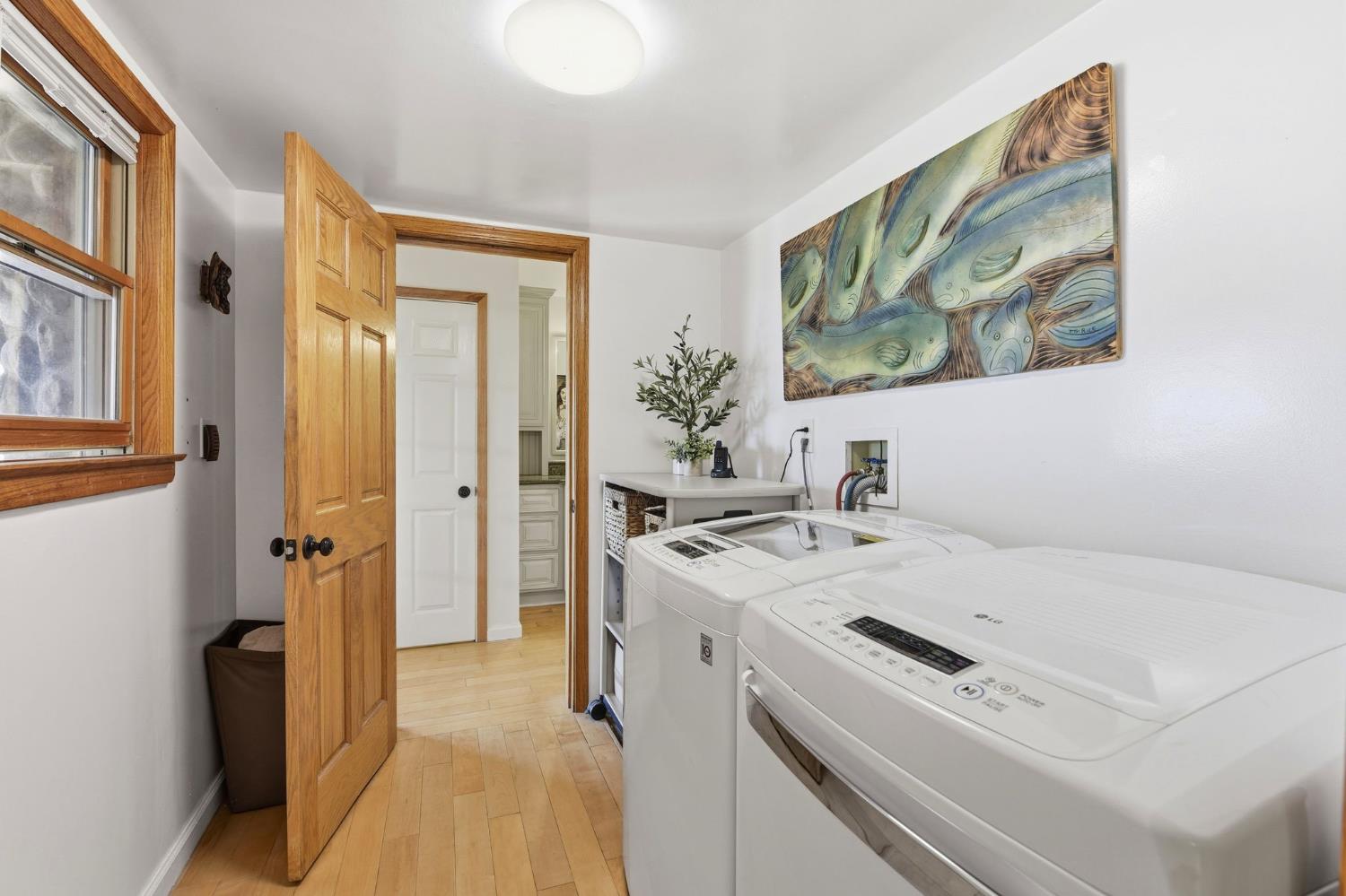 7201 Happy Valley Road Somerset, CA 95684 - Photo 30 of 75 The laundry room is conveniently located in a Jack and Jill arrangement that leads out to the hallway for guests or family members to use and the primary bathroom.