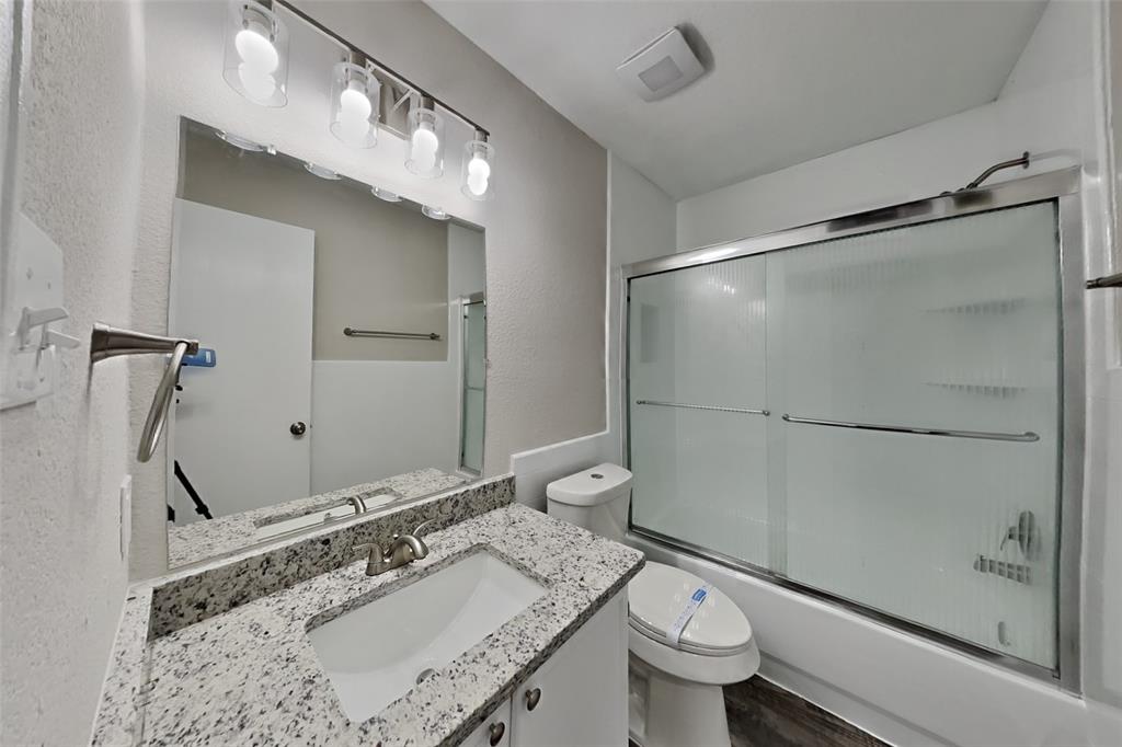 2005 Fairview Drive Forney, TX 75126 - Photo 16 of 18 a bathroom with a granite countertop sink toilet and shower