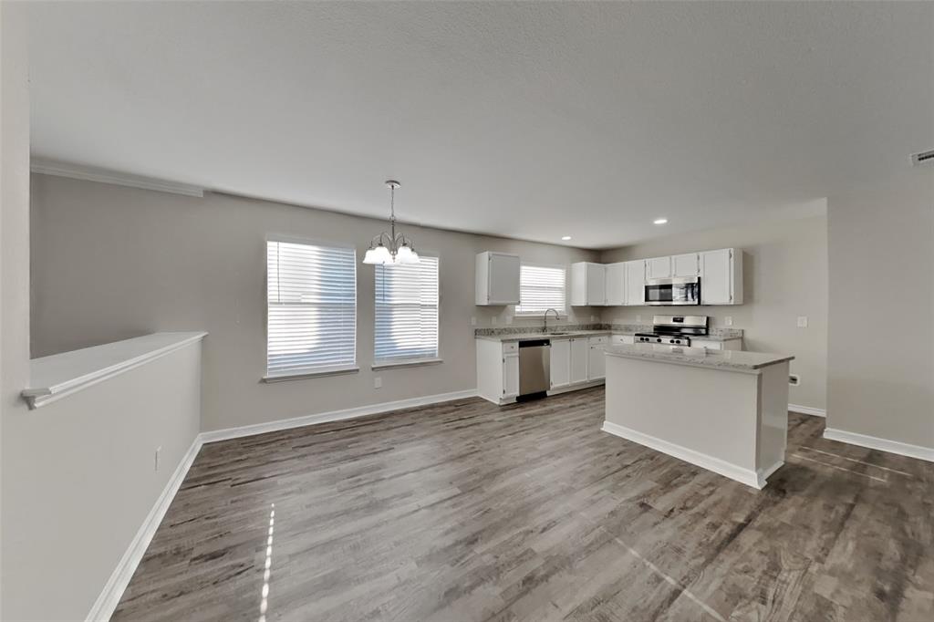 2005 Fairview Drive Forney, TX 75126 - Photo 4 of 18 a large white kitchen with kitchen island a sink stainless steel appliances and cabinets