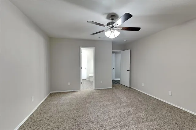 a view of an empty room with a fan