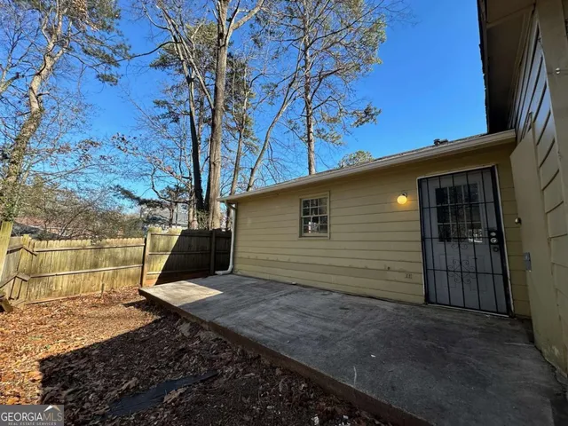 a view of a backyard with a large tree