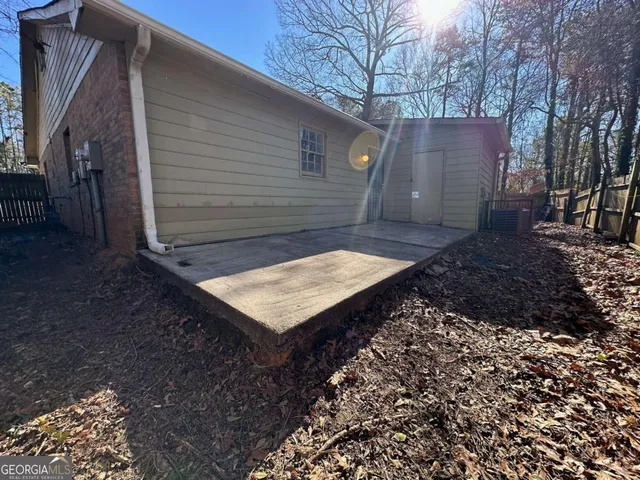 a wooden bench sitting in front of a house