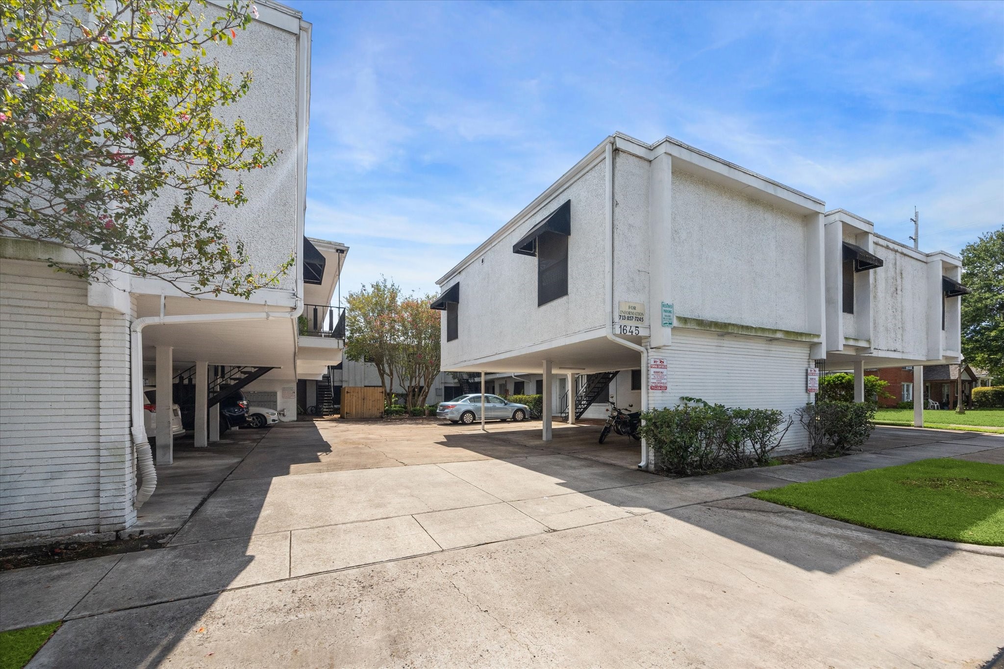 a view of a patio with a table and chairs under an umbrella