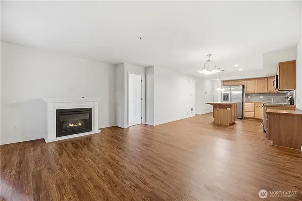 a view of open kitchen with furniture and fireplace