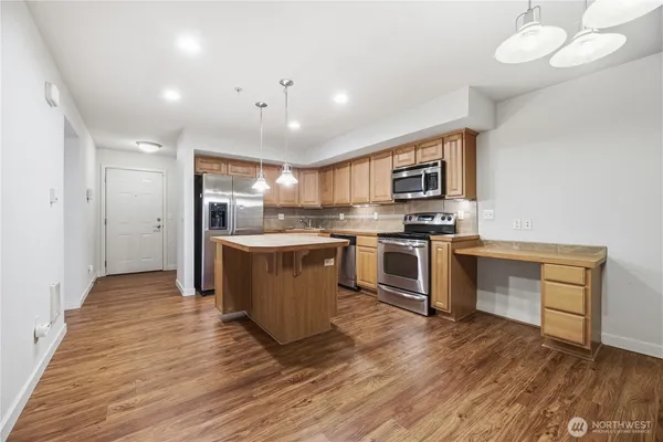 a kitchen with a sink cabinets and stainless steel appliances
