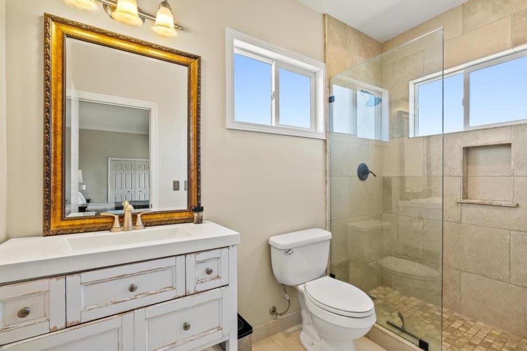 432 River Road Salinas, CA 93908 - Photo 53 of 64 a bathroom with a toilet a sink a mirror a shower and vanity