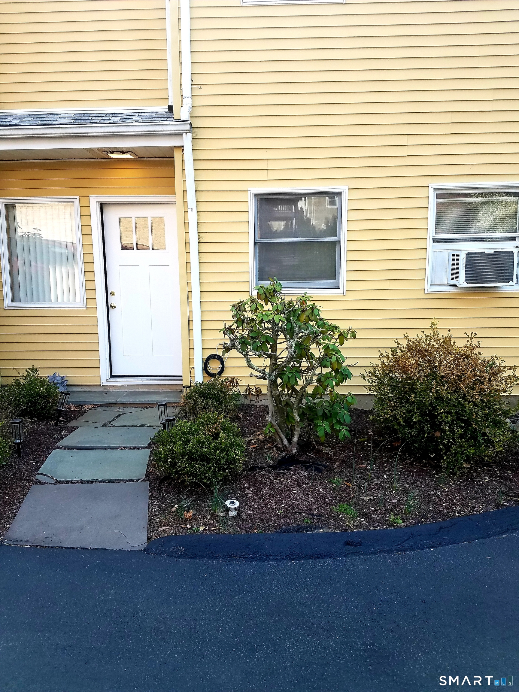 72 Maple Tree Avenue, Unit 2 Stamford, CT 06906 - Photo 2 of 25 a front view of a house with garden